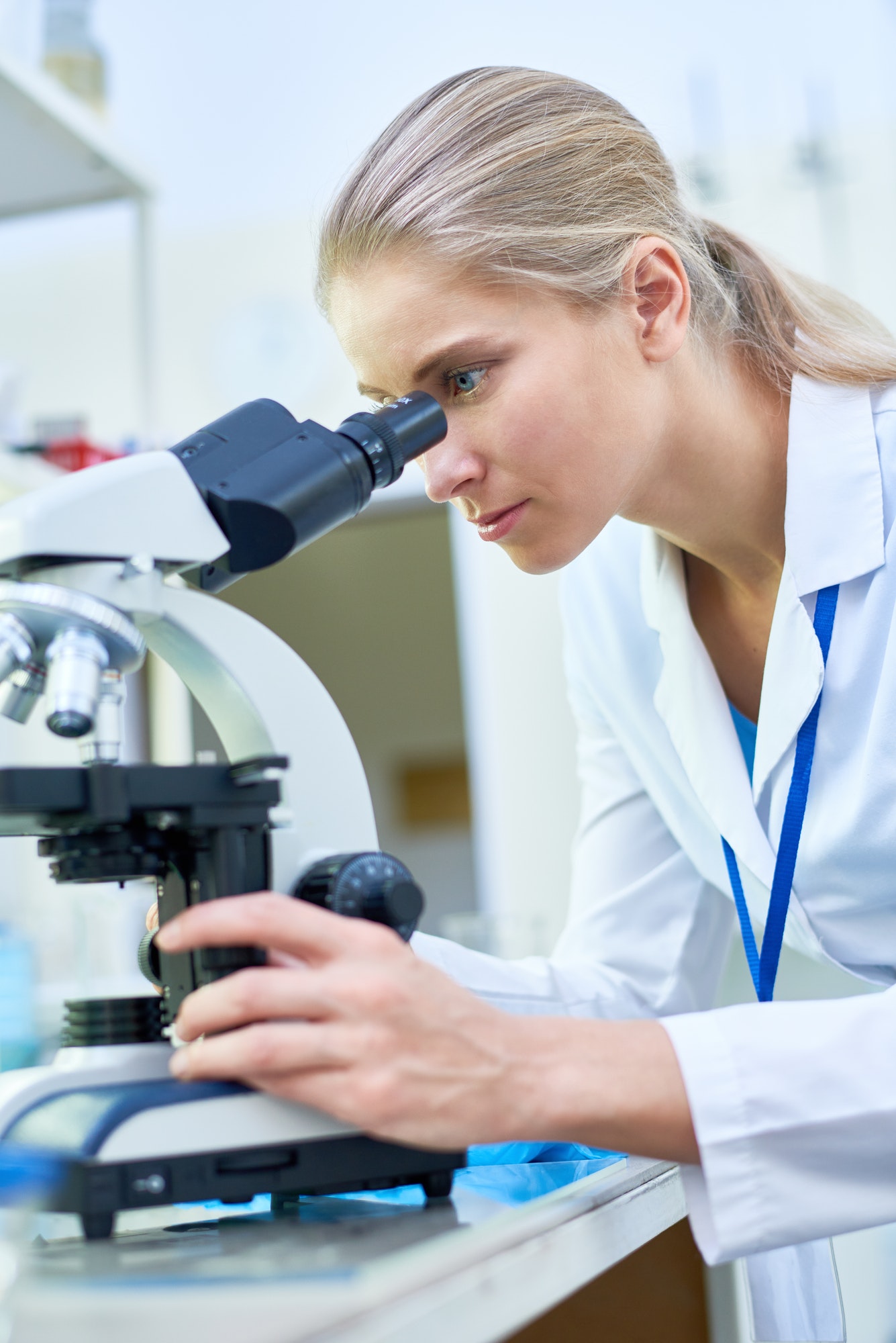 Female Scientist Using Microscope