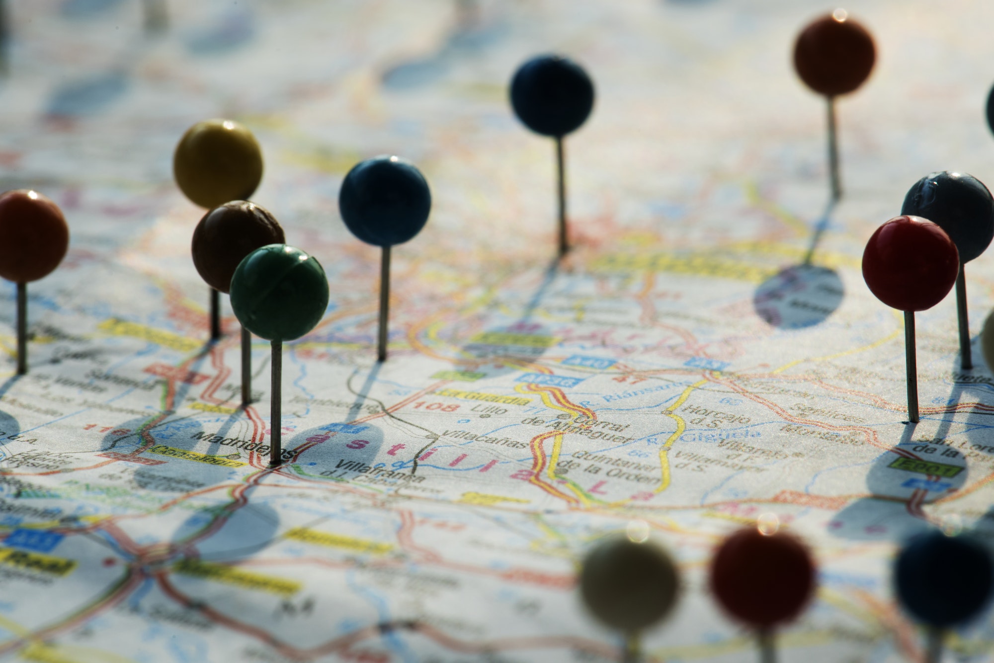 Closeup of pins on the map planning travel journey Closeup of pins on the map planning travel journey