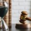 Hourglass and gavel on table
