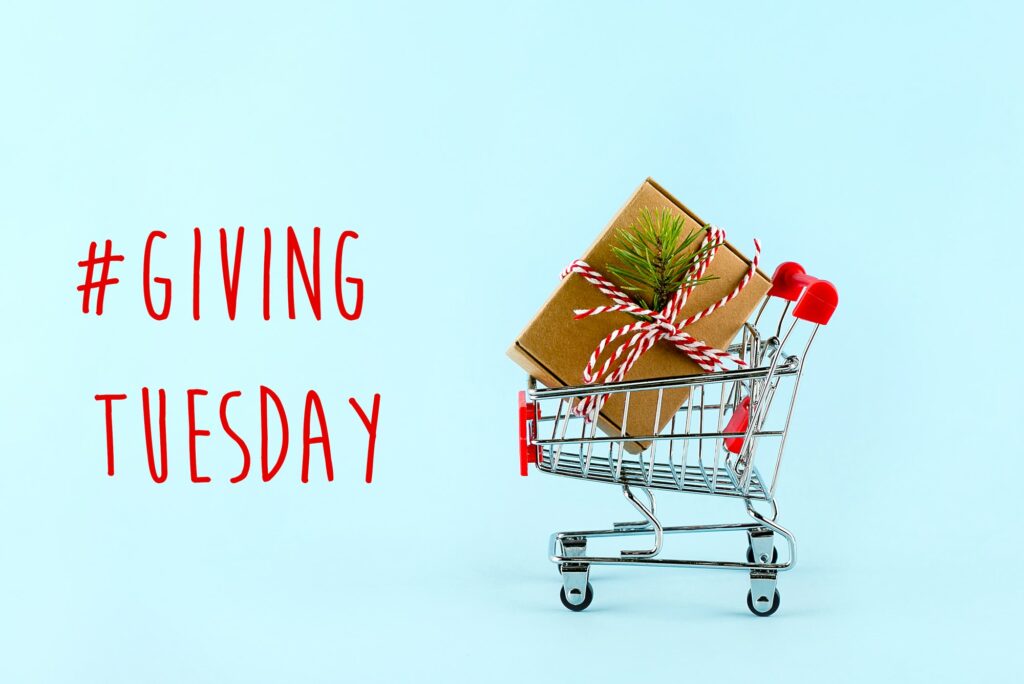 Giving tuesday holiday. Trolley with gift box. Charity, donations concept. Giving tuesday holiday. Trolley with gift box. Charity, donations concept.