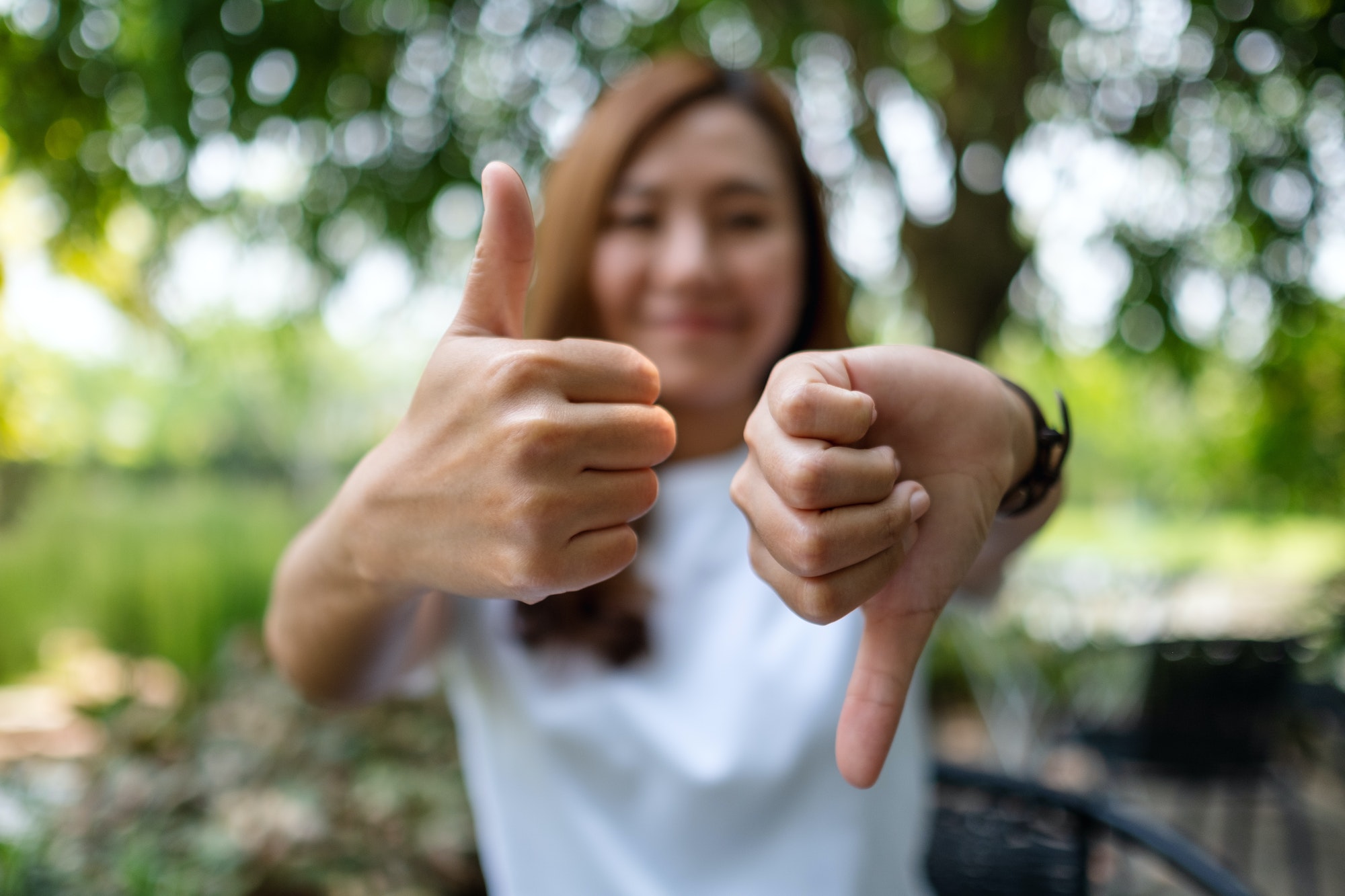 woman with four arms holding different sports items in each hand