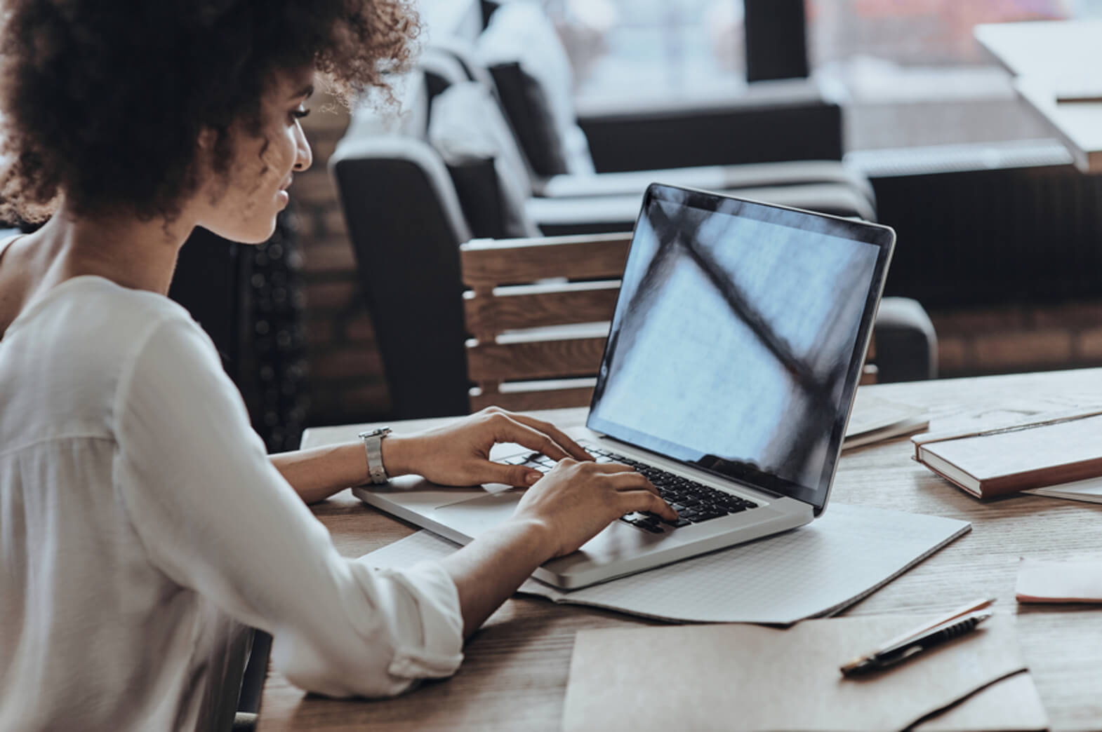 A woman works on a laptop in a nonprofit office.