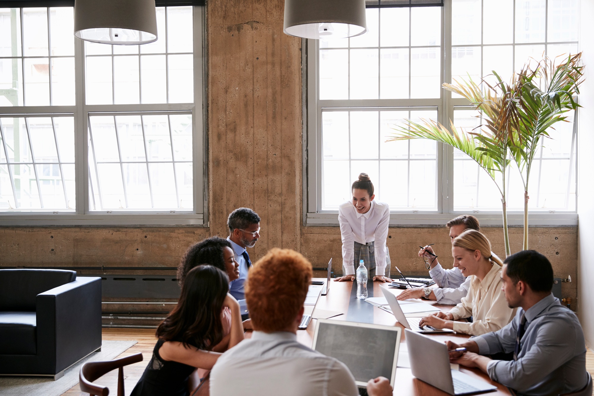 How to Run an Effective Nonprofit Board Meeting: 7 Trust-Building T Female manager addressing team at board meeting
